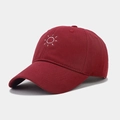 Close-up of deep red baseball cap featuring detailed white sun embroidery and cotton twill - Adjustable / Burgundy