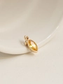 Detail of 18K gold plated marquise-cut yellow zircon pendant on white ceramic plate - November/Yellow