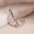 Irregular silver geometric open ring displayed on a natural light stone surface - Silver