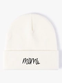Close-up of the fine knitted texture and black mimi embroidery on a white beanie hat - White
