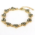 Detail of gold heart bracelet featuring black enamel links and sparkling zircon stones - Black