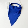 Close-up of a blue satin headscarf with elastic band laid on a white textured background - Satin Royal Blue