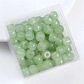 Macro view of light green cylindrical glass beads stored in a clear acrylic box container - Barrel Bead 8x6mm / Green