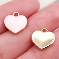 Pink enamel and gold heart charms held on fingers for DIY jewelry making - Pink Heart (21194)