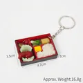 Miniature bento box keychain featuring realistic braised pork and rice food model - Chicken Wing & Veggie Rice Bento