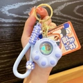 Cute lavender cat paw keychain with a colorful crystal ball and soft wrist strap - Purple