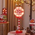 Christmas Santa Stop Here LED octagon sign with warm lights on a red metal stand - Octagonal STOP Sign