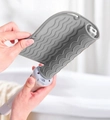 Gray heat-resistant silicone mat wrapped around hair straightener for thermal protection - Gray