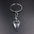 Macro shot of a clear hexagonal crystal point pendant on a silver keychain with link chain - Clear White