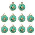 Detailed view of ten turquoise enamel round bee pendants with gold-plated alloy frames - Green