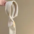 Close-up of elegant cream silk headband featuring long flowing ribbons in French style - Cream