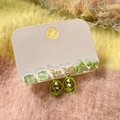Detail view of silver needle earrings set with zircon pearls and green floral charms - 12# Green Tone (6 Pairs)