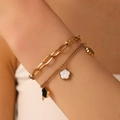 Double-layered gold stainless steel bracelet with black and white flower charms on wrist - Gold Double Layer Five-Petal Flower Style