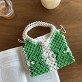 Handmade woven cotton rope tote bag with green hollow patterns on a wooden table - Green