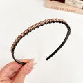 Minimalist black hairband with double-row champagne rhinestones held in hand - Champagne