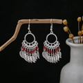Detail of bohemian ethnic earrings with silver leaf tassels and red beads on wood - Hollow Ring Leaf Tassel Red Beads Style (E4949-1)