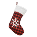Close-up of red and black buffalo plaid Christmas stocking with white faux fur and snowflake - Snowflake