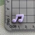 Mini violet resin music note charm for DIY crafts measured on a metric scale ruler - Purple