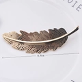 Detailed view of a 9.8cm golden feather metal hair clip with intricate texture - Gold Leaves