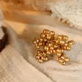 Christmas gold berry cluster decoration with a matte finish for rustic holiday wreaths - Triple Stem Gold Berries