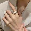 Adjustable golden ring featuring a white heart shell inlay and a round sparkling gem - Heart Shell