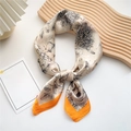 Beige floral silk scarf with orange border tied on a stylish wooden tray display - Sketch Floral Orange