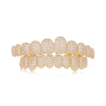 Iced out gold plated hip hop grillz set with clear cubic zirconia stones on white background - Gold Standard