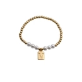 Detail of beaded bracelet with gold metal spheres, white pearls, and a letter V charm - Letter V
