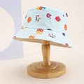 Detail view of light blue children bucket hat with colorful fruit pattern on wooden stand - Kids One Size / Light Blue (Tutti Frutti Fruit)