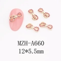 Macro view of 12x5.5mm pink rhinestone bow charms on gold alloy base for DIY nail art - Ribbon Bowknot (A660)
