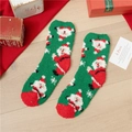 Green coral fleece Christmas socks featuring Santa Claus patterns and warm red toe caps - Full Body Santa