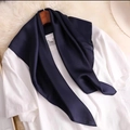 Solid navy blue silk scarf on a white tee with a wooden hanger and straw hat - Navy Blue