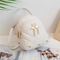 White mini backpack with diamond quilting, swan charm, and gold-tone zippers - White