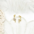 Macro view of 18K gold plated lightning bolt pendants with cubic zirconia on lace - Flash