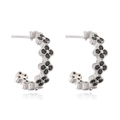 Detailed view of silver clover earrings featuring inlaid black stones with reflection - Platinum Black Zirconia