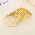 Polished 18k gold stackable bangle set featuring smooth and textured finishes - Inner Diameter 68mm / Set of 12 / Gold