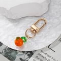 Porte-clés fait main en verre orange avec fermoir doré et pendentif feuille verte - Kaki
