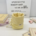 Detailed view of yellow plaid drawstring stationery pouch with Sozanni woven label - Yellow Plaid