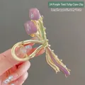 Detail view of 11cm purple tulip ribbon hair claw clip with golden enamel base - K73 Purple Tulip