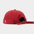 Detail view of red brimless cap featuring N embroidery and adjustable brass buckle - Burgundy