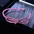 Dettaglio del cerchietto con fiocco di strass rosa scintillanti e punte metalliche dorate - Fascia Sottile Annodata con Strass Rosa Completi