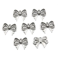 Close-up of seven silver hollow bow pendants for DIY jewelry making and necklaces - No. 16 Bowknot-Silver-15*18mm