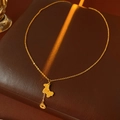 Macro view of gold-plated pony pendant necklace on luxury brown leather jewelry box - Necklace - Gold Coin (Real Gold Plated)