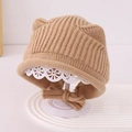 Detailed view of beige knit baby hat with bear ears and bow tie on display stand - 1-3 Years / Khaki