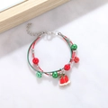 Detail of red and green woven Christmas bracelet with silver beads and red bell charm - Style L Double Layer Bell