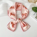 Pink twilly silk scarf with cartoon pumpkin prints and checked edges tied in a bow - Pink Pumpkin