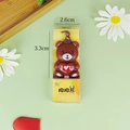 Brown Cuddle Bear candle wearing a party hat and holding a red heart for cake decoration - Cuddle Bear Brown Candle