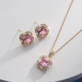 Close-up of golden necklace and earrings set with pink square stones and small diamonds - Gold Square Pink (HQ0001(18))