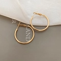Detailed view of polished golden hoop earrings featuring a glossy metallic finish - 3cm / Gold