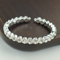 Macro shot of silver adjustable open bangle with sparkling cubic zirconia crystals - Silver